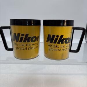 2 Vintage Nikon Mug Thermal Plastic Weighted Base Black Yellow Logo USA⬇️